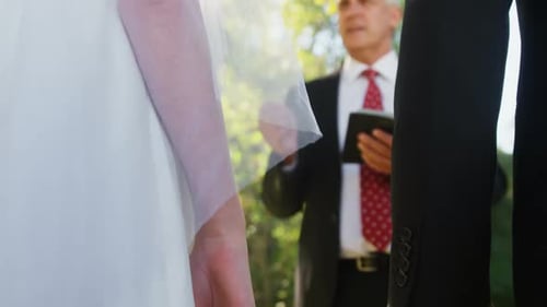 Bride and Groom Holding Hands at Wedding Ceremony