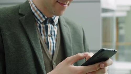 Young Businessman Messaging on Smartphone
