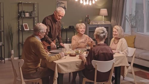 Friends Gather for Dinner at Home, Pouring Wine