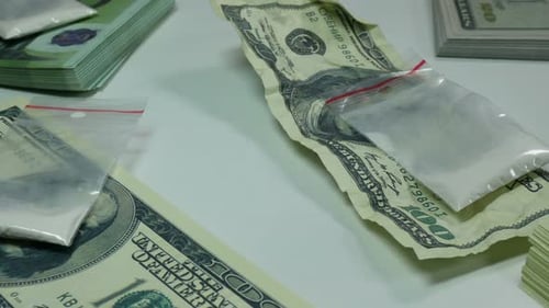 Stacks of Cash and Bags of White Powder