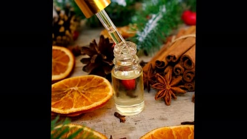 Dropper dispensing essential oil with seasonal decorations