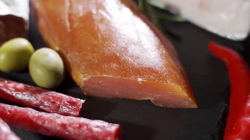 Assorted Deli Meats, Ham, Salami, Bacon and Tomatoes on the Black Stone Tray