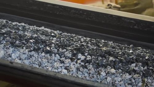 Pile of coal moves on belt conveyor at factory