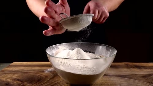 Sifting White Flour Into Bowl For Baking