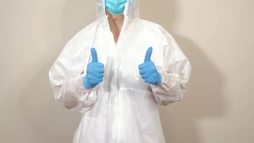 Worker in Protective Suit Gives Thumbs Up