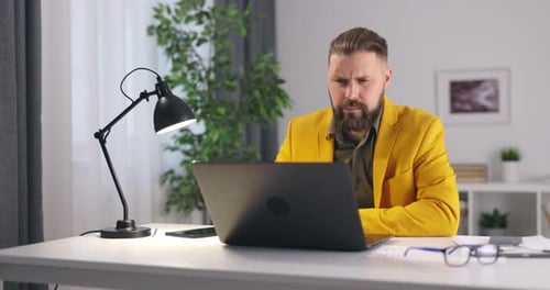 Man Works at Desk in Home Office
