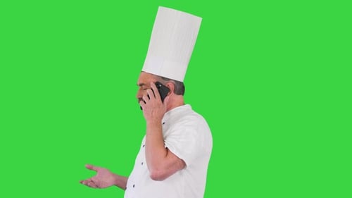 Male Chef Cook with Calling on Smartphone on a Green Screen Chroma Key