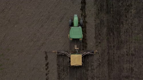 Tractor Sowing Farmland from Aerial Birds Eye View