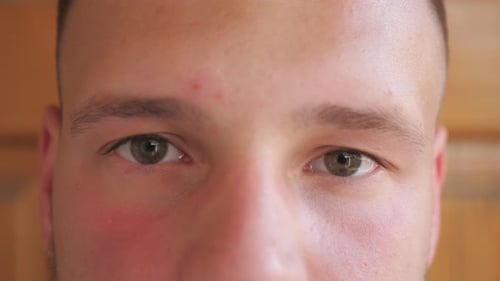 Close Up Green Eyes of Guy Staring and Blinking with a Confident Sight Outdoor