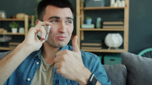Young Adult Man Talking on Phone Indoors