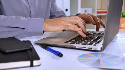 Unrecognizable Worker Surfing Internet on Computer