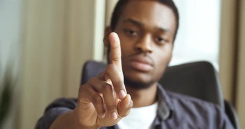 Afro American Business Man Freelance Entrepreneur Sitting at Table in Office Home Shaking His Finger