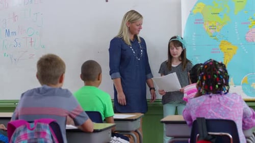 Student in front of class reading report