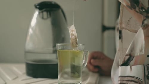 Anonymous woman making tea with tea bag