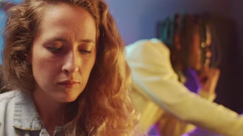 Woman Playing Synth while Working with Colleague in Recording Studio