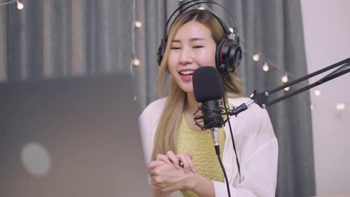 Young Woman Speaking Into Microphone for Podcast