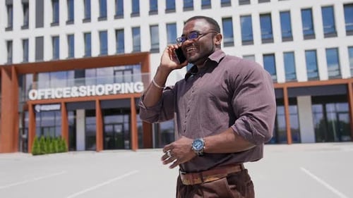 Black man talking on the phone in the street