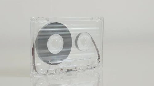 Analogue magnetic tape on white background 4K 2160p 30fps UltraHD footage - Close-up vintage transp