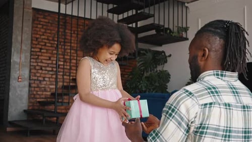 Girl Receives Birthday Gift from Father and Hugs Him