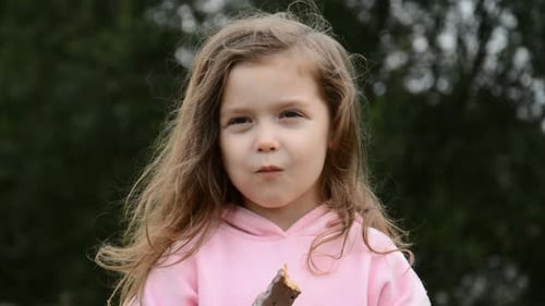 Portrait of a Beautiful Little Girl Eating Chocolate