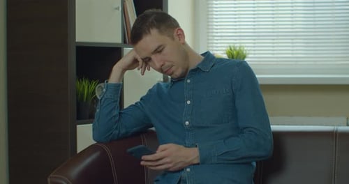 Man on Couch Using Mobile Device Indoors