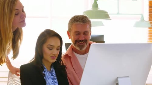 Colleagues collaborate in brightly lit office