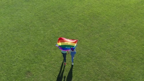 Aerial View of People Holding Pride Flag on Lawn