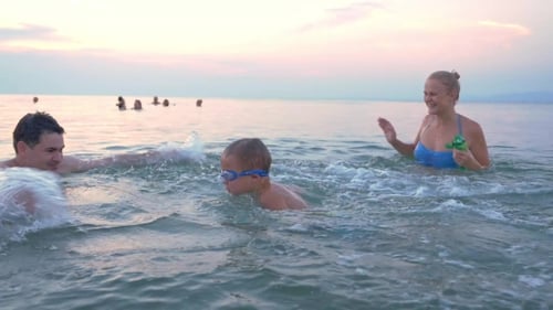 Happy Family Having Fun In Water On Vacation