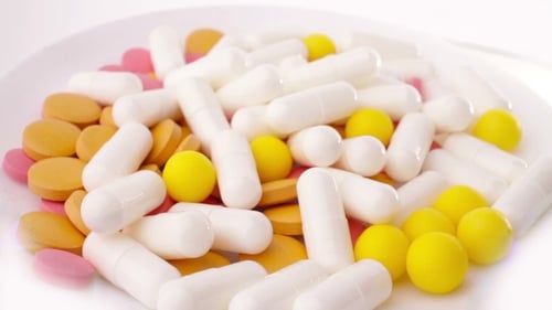 Assorted Pills and Capsules Rotating on Plate