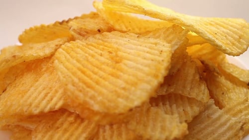 Potato Chips Heap Rotating Over White Background