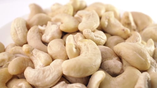 Rotating Close up of Delicious Cashews on White