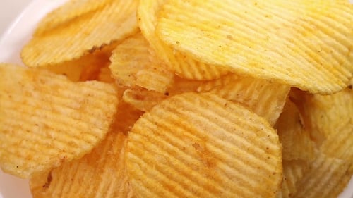Potato Chips Heap Rotating Over White Background, View