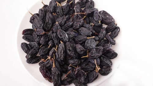 Plate of Plump Black Raisins Close Up