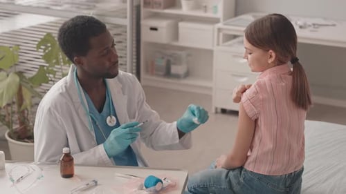 Friendly Doctor Giving Child a Vaccine Shot