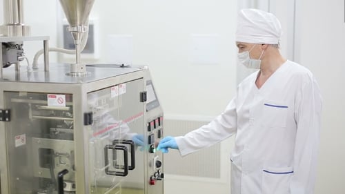 Technician Starts Factory Packaging Machine