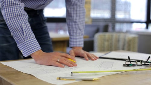 Engineer Designer Checks the Construction Drawings