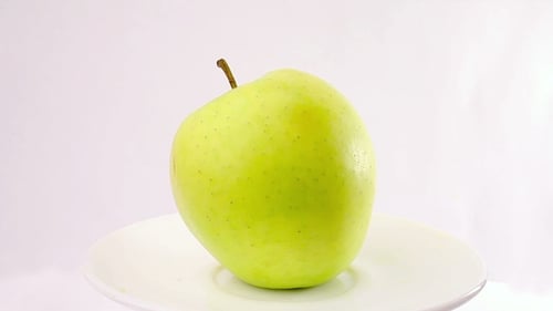 Green Apple Rotation On a White Background
