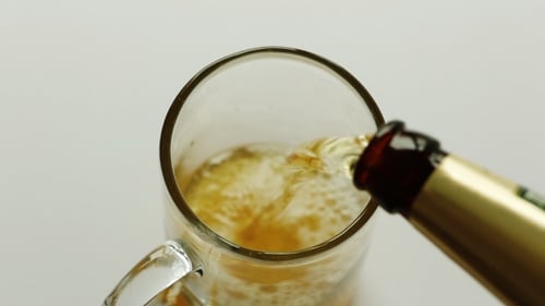 Beer Being Poured into Glass Mug