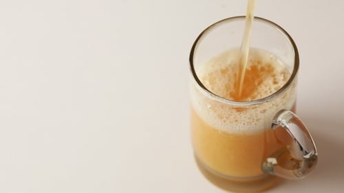 Foamy Beer Pouring into Glass Mug, Overflowing