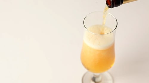 Foamy Beer is Poured into a Glass