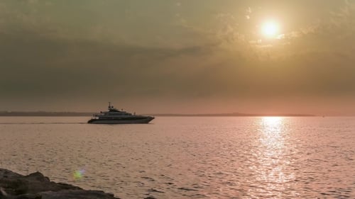 Yacht Sailing on Water at Sunset