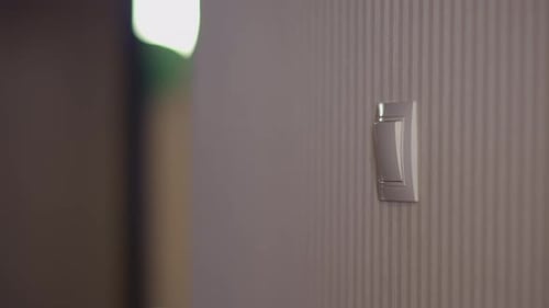 Man Leaves the Room and Turns Off the Light
