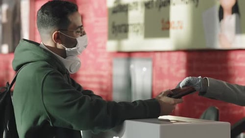 Young Adult Interacting with Public Service Worker