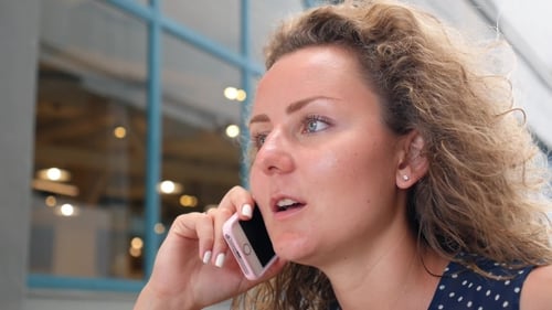 Woman Talking on Phone in Urban Setting