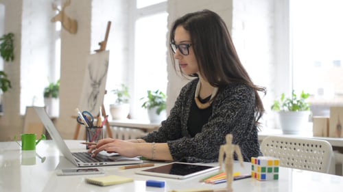 Woman Working on Laptop in Bright Office