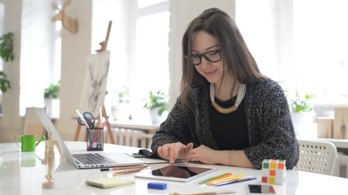 Woman Using Tablet Device at Bright Desk