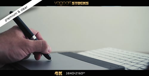 Hand Using Digital Pen on Tablet at Desk