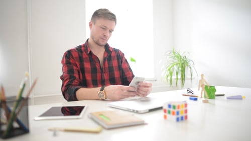 Checking Message on Smartphone in Creative Office