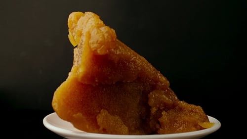 Rotating Block of Halva Dessert on Plate