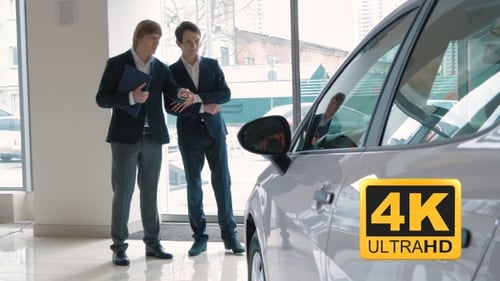 Young Men in Suits Discuss Car Purchase